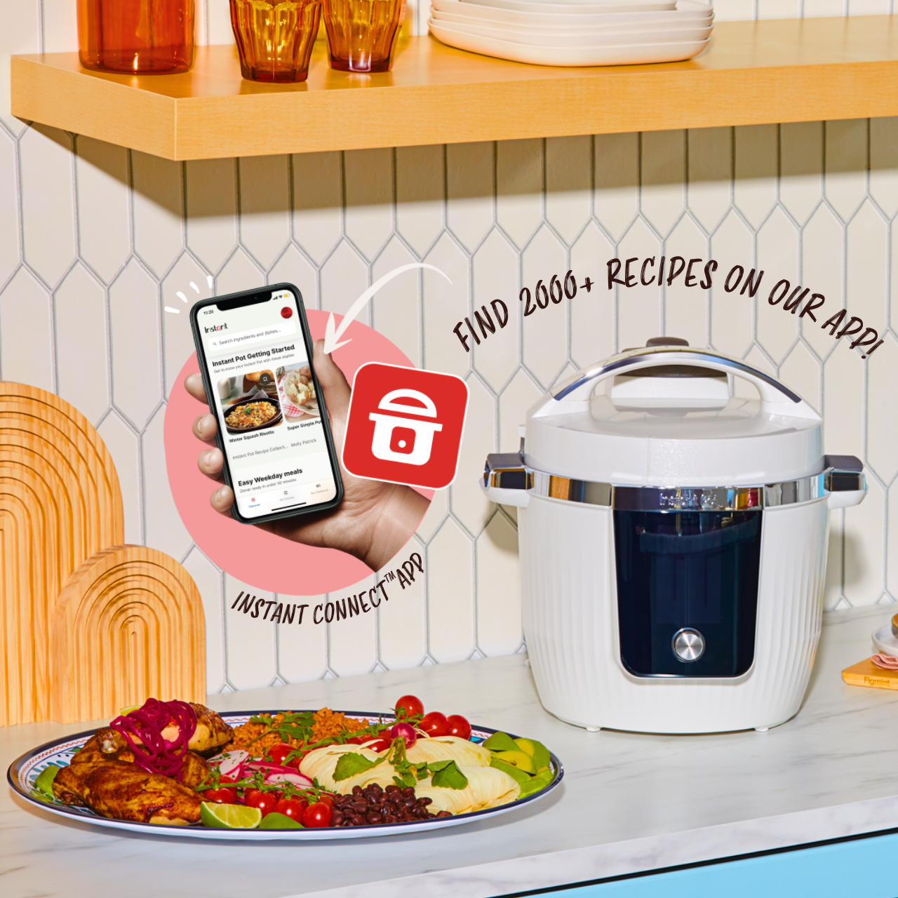 A white and chrome Instant Pot sits on a kitchen counter next to a colorful plate of food including grilled chicken, tamales, black beans, rice, and fresh vegetables. A hand holding a smartphone displays the Instant Connect™ app interface with recipes. Text around the image reads, “FIND 2000+ RECIPES ON OUR APP!” and “INSTANT CONNECT™ APP,” with an arrow pointing from the phone to the app icon. The background features white tile backsplash and a wooden shelf with glasses and stacked plates.