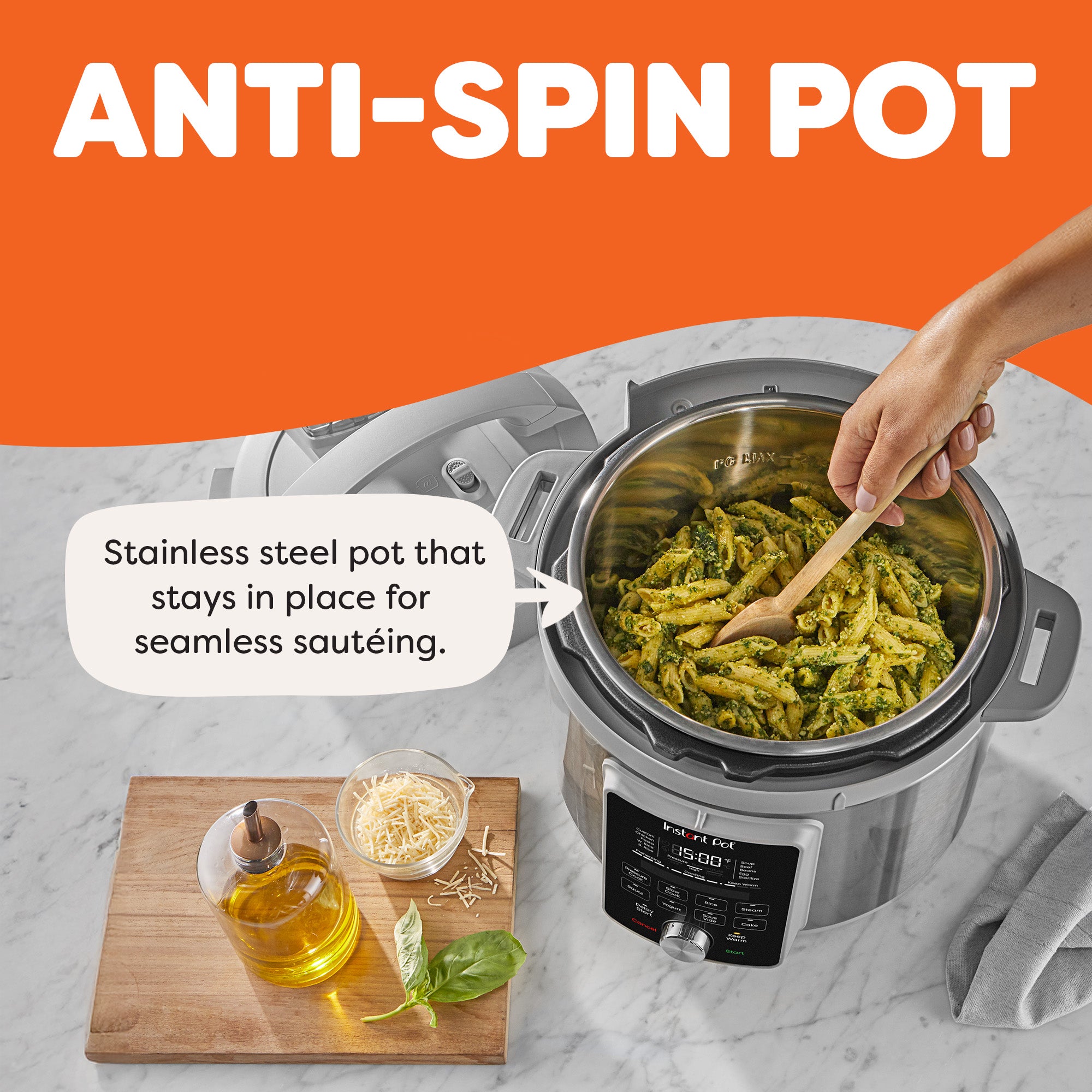 Hand stirring pesto pasta inside an Instant Pot Duo Plus. The stainless steel pot stays in place while cooking. A cutting board with olive oil, shredded cheese, and basil is nearby. Text highlights the anti-spin pot feature.