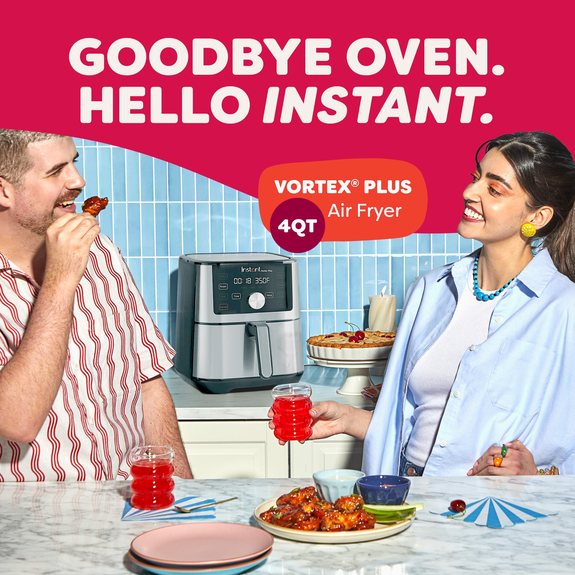 Smiling man and woman enjoying snacks and drinks in a kitchen with an Instant Vortex Plus 4QT Air Fryer on the counter between them. The countertop displays wings, red beverages, and dessert, with a pie in the background. Bold text above reads 'Goodbye Oven. Hello Instant.' with a label highlighting 'Vortex® Plus 4QT Air Fryer.