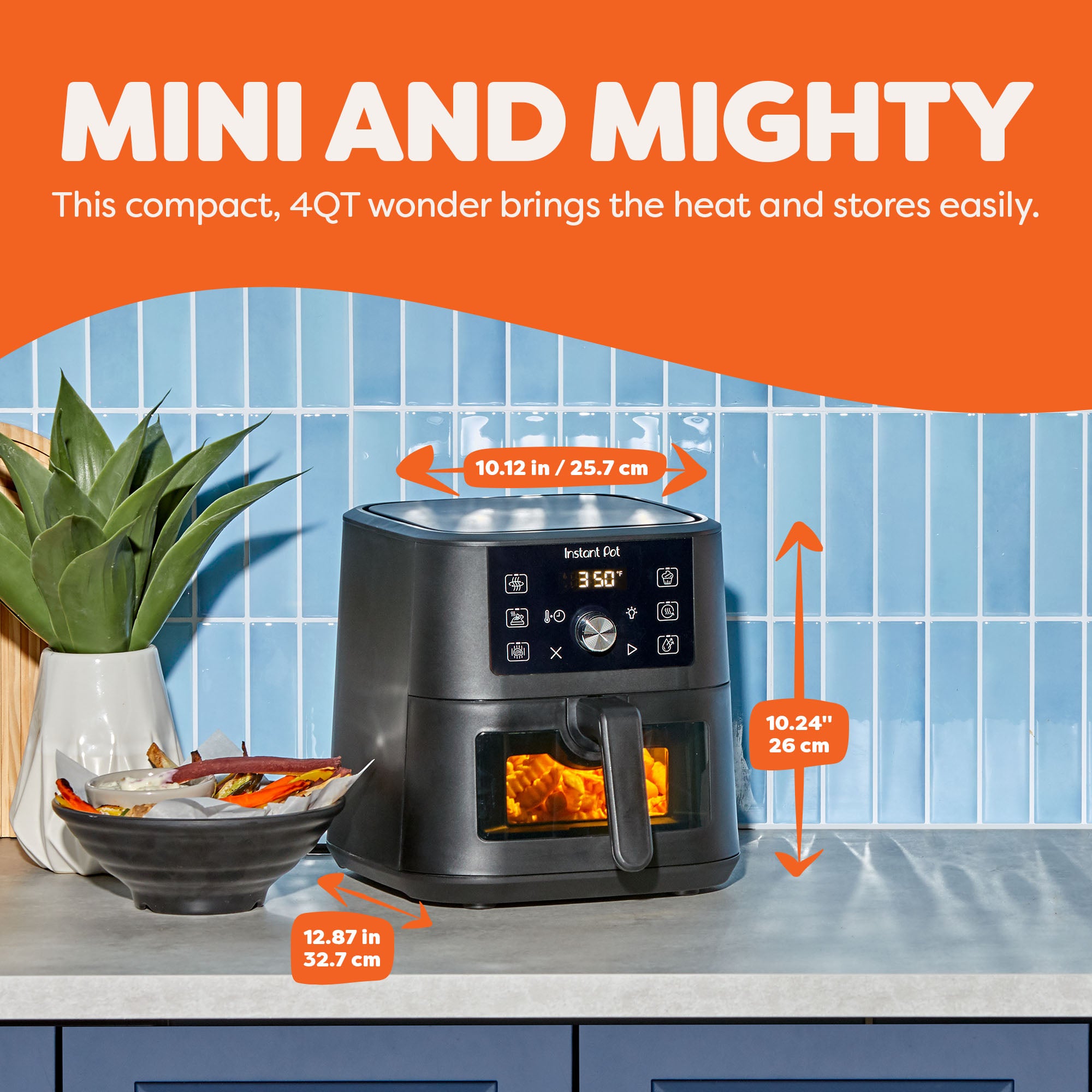 Instant Pot® 4QT Vortex® Plus Mini Air Fryer in Black on a kitchen counter, with dimensions labeled: 10.12 inches wide, 10.24 inches tall, and 12.87 inches deep. The appliance displays 350°F and has fries cooking inside, next to a bowl of sweet potato fries and a potted plant, with the headline “Mini and Mighty.”