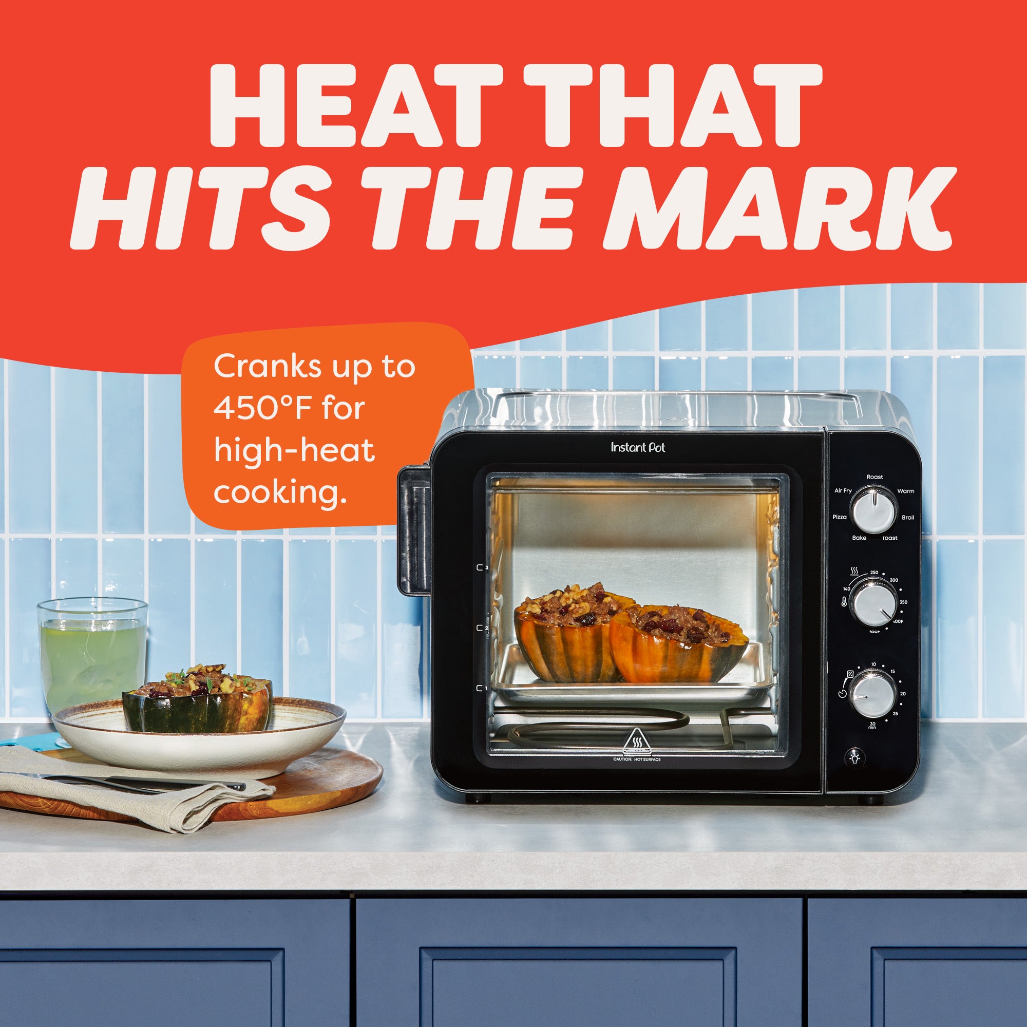 Two squash halves roast inside the Instant Pot® 4-Slice InstantHeat™ Mini Air Fryer Toaster Oven. Text reads “Heat That Hits the Mark,” emphasizing the appliance can reach 450°F for high-heat cooking.