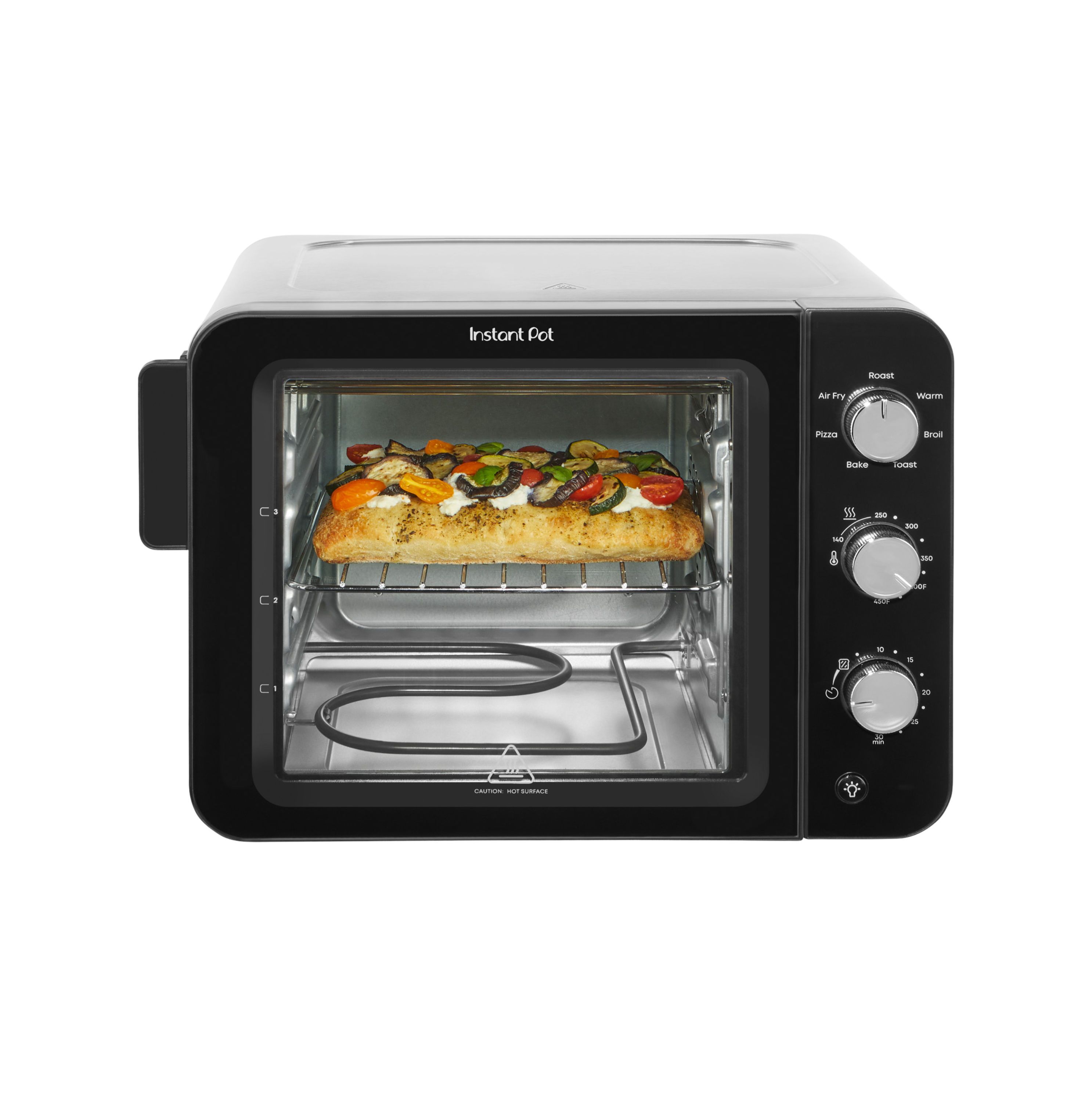 Front-facing view of the Instant Pot® 4-Slice InstantHeat™ Mini Air Fryer Toaster Oven with the door closed. A slice of focaccia bread topped with vegetables and cheese is baking on the middle rack. Manual control dials for temperature, timer, and cooking functions are on the right side of the unit.
