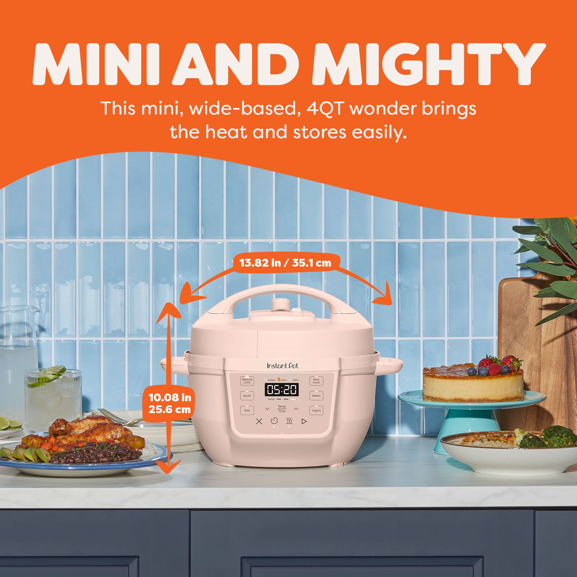  Instant Pot® 4QT RIO™ Mini Multi-Cooker in Rosewater displayed on a kitchen counter with dimensions labeled—13.82 inches (35.1 cm) wide and 10.08 inches (25.6 cm) tall. The appliance sits between plated dishes and desserts, highlighting its compact, wide-based design ideal for tight spaces. The text above reads “Mini and Mighty: This mini, wide-based, 4QT wonder brings the heat and stores easily.”