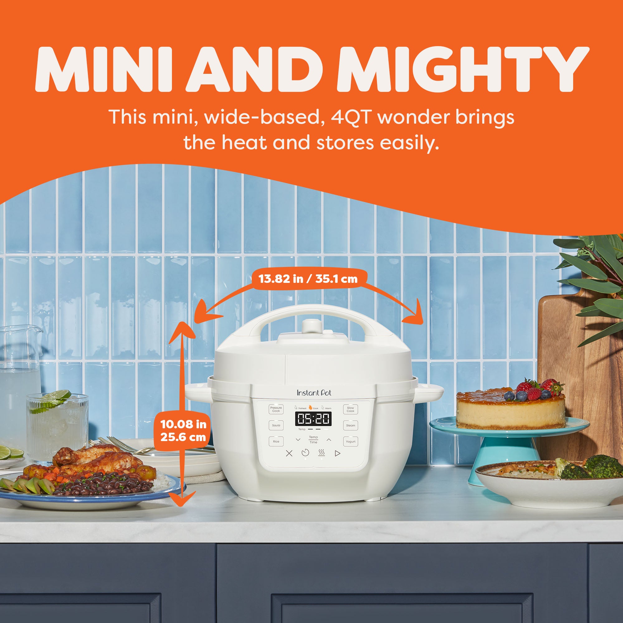  Instant Pot® 4QT RIO™ Mini Multi-Cooker in Sea Salt displayed on a kitchen counter with dimensions labeled—13.82 inches (35.1 cm) wide and 10.08 inches (25.6 cm) tall. The appliance sits between plated dishes and desserts, highlighting its compact, wide-based design ideal for tight spaces. The text above reads “Mini and Mighty: This mini, wide-based, 4QT wonder brings the heat and stores easily.”